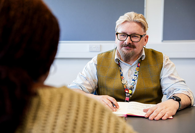Two people sitting across each other