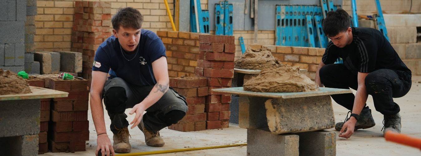 Two students working in brick workshop