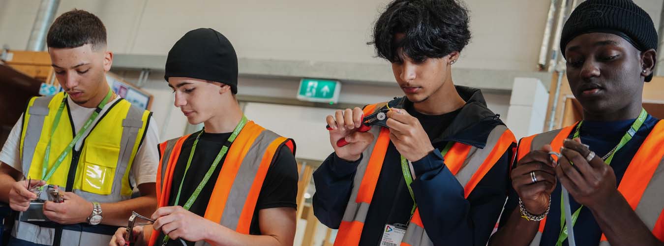 Students holding and cutting wires