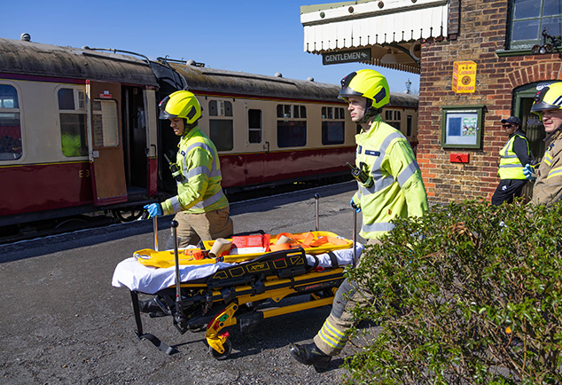 Students wearing emergency services uniform at train station