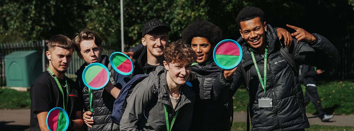 Group of students standing together outside posing for camera