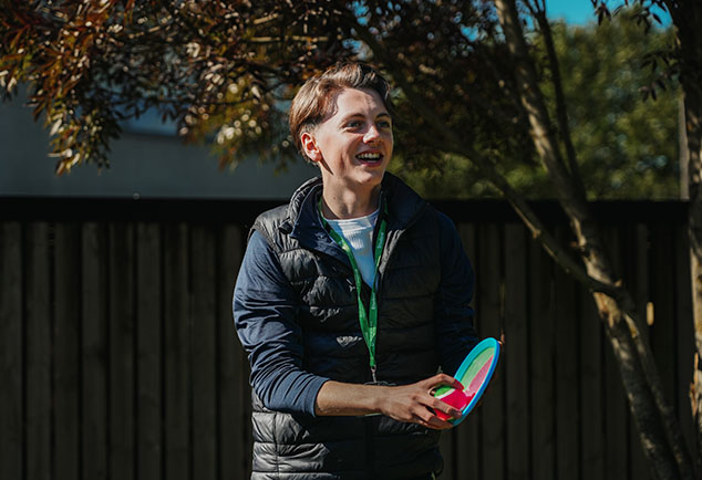 Student playing ball game outside