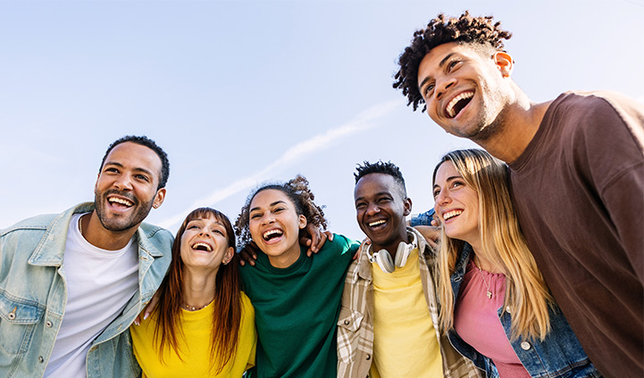 Group of people standing together smiling