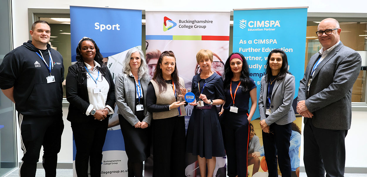 Buckinghamshire College Group staff with CIMPA holding a plaque.