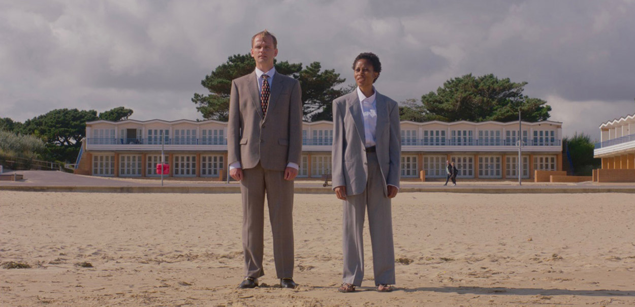 Two people standing on a beach